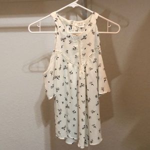 A flowly cold shoulder high collar top